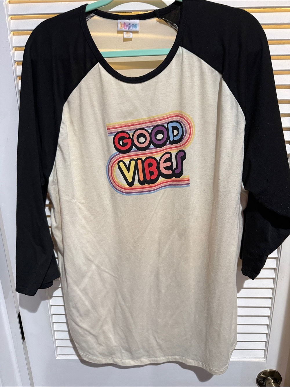 LuLaRoe Cream Tee with Black Trim and Multicolor Logo